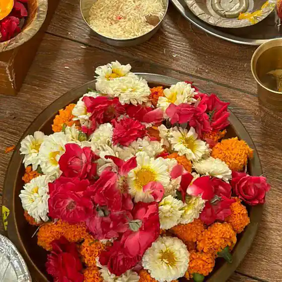 A plate of red roses, white flowers and marigolds
